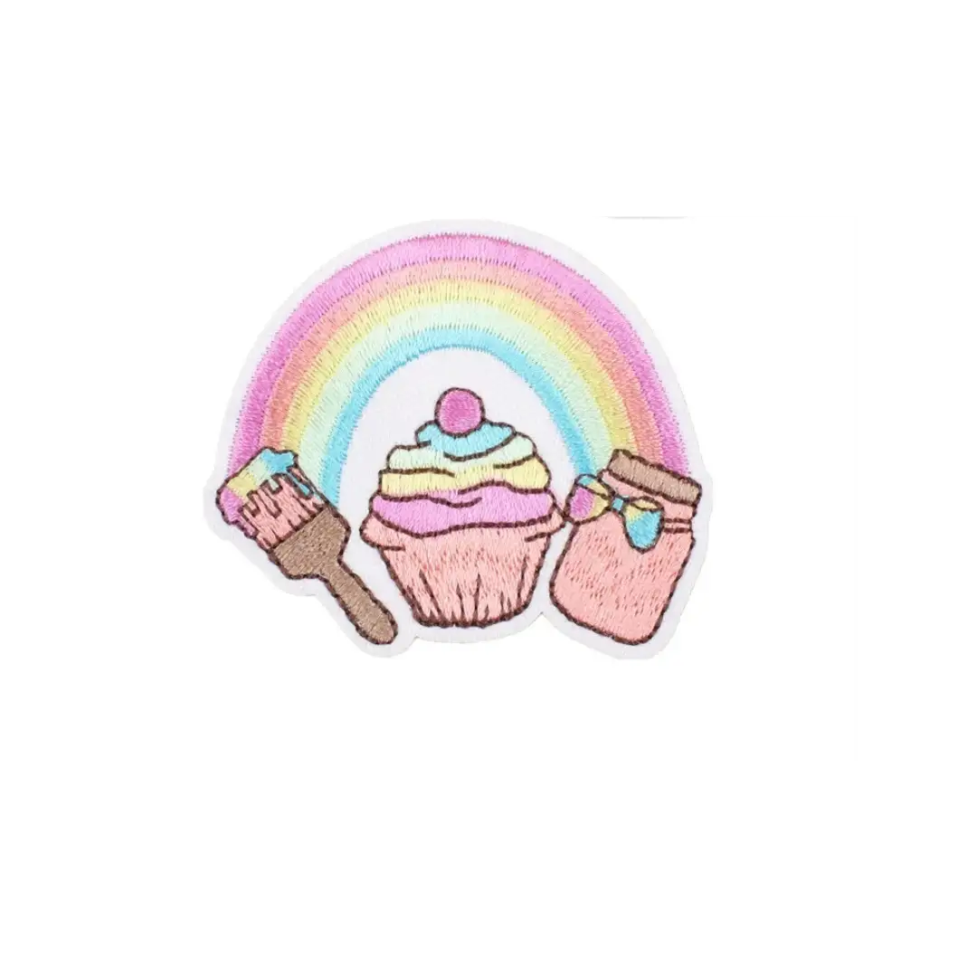 Pastel rainbow embroidered patch featuring a cupcake, paintbrush and jar