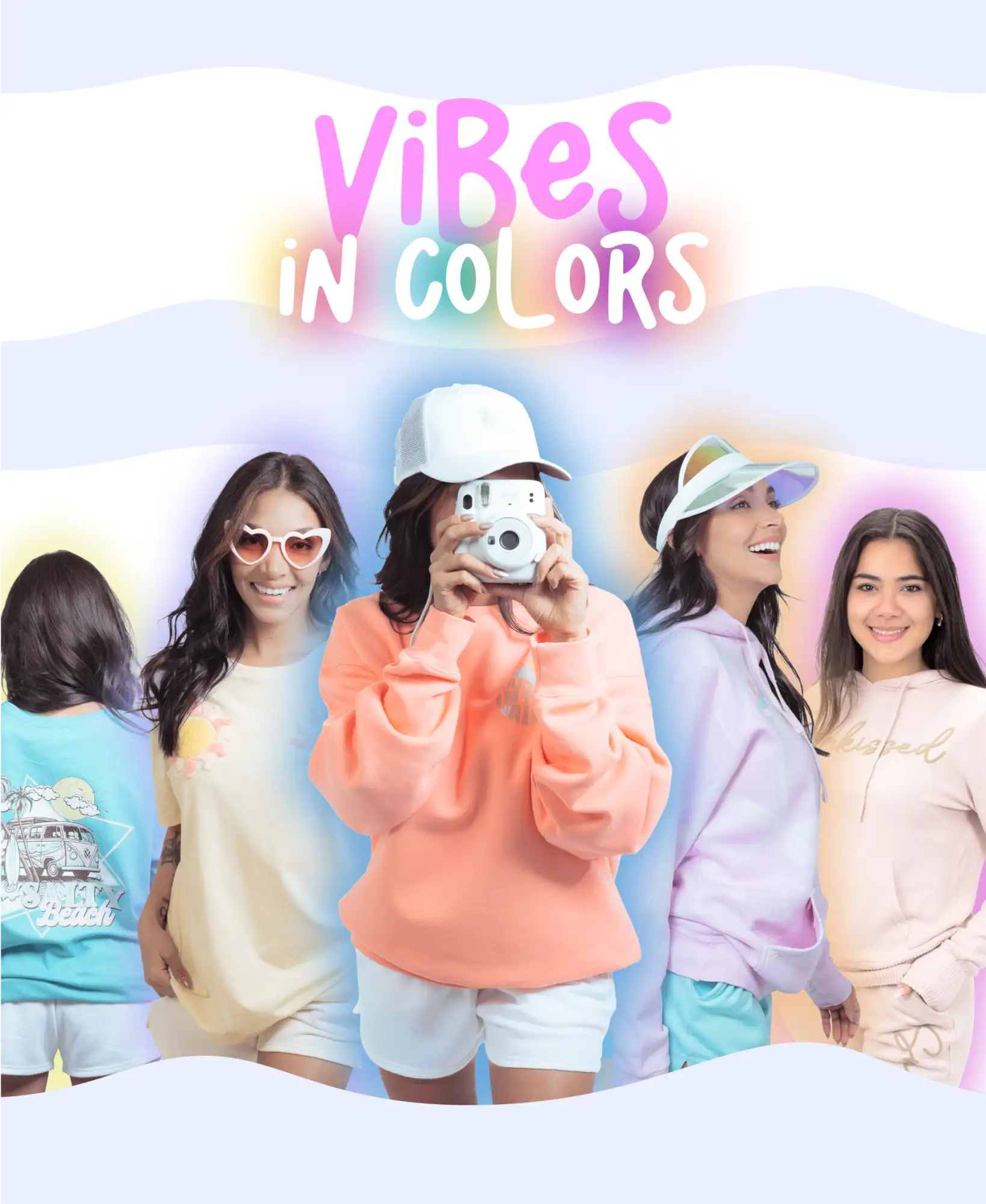 White instant camera held by a person in an orange sweatshirt